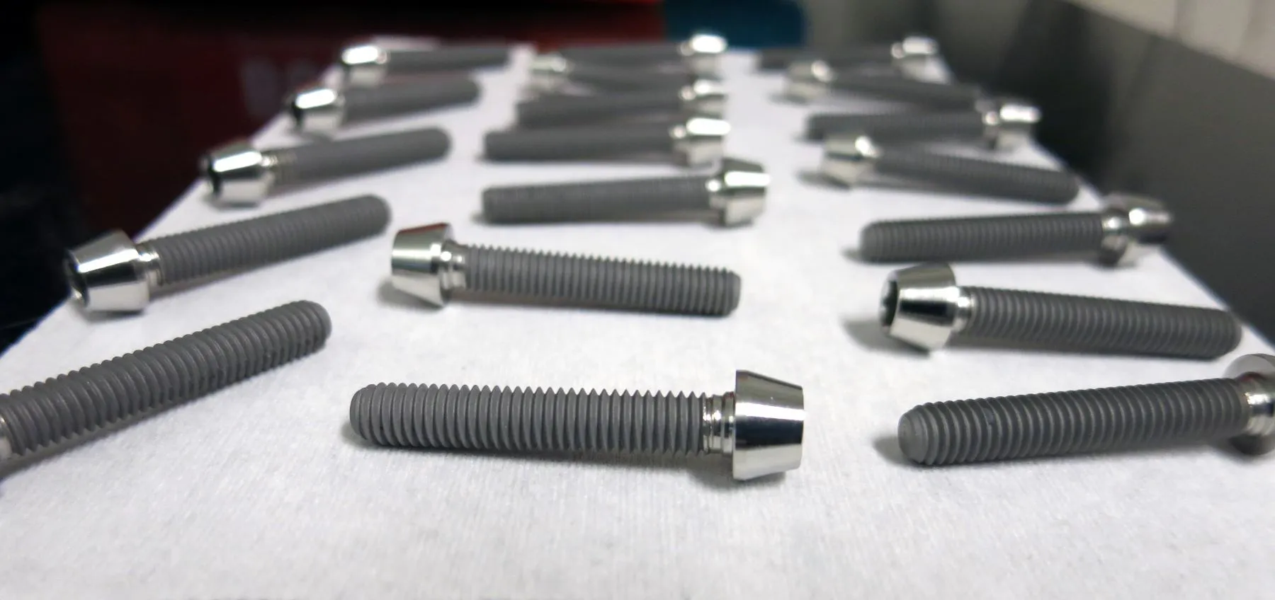 Titanium bolts with an anti-galling fluoropolymer coating